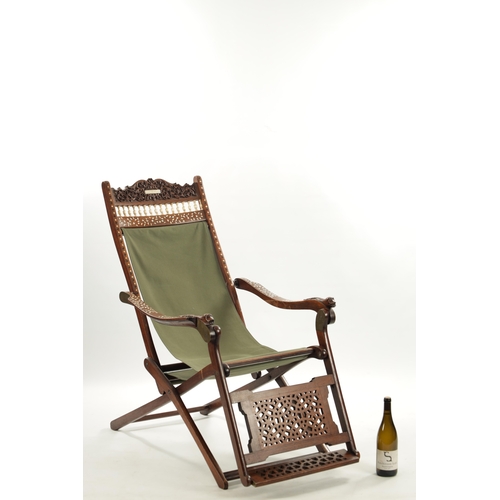 557 - A LATE 19TH CENTURY ANGLO INDIAN IVORY INLAID HARDWOOD FOLDING CHAIR with ivory balustrade and carve... 