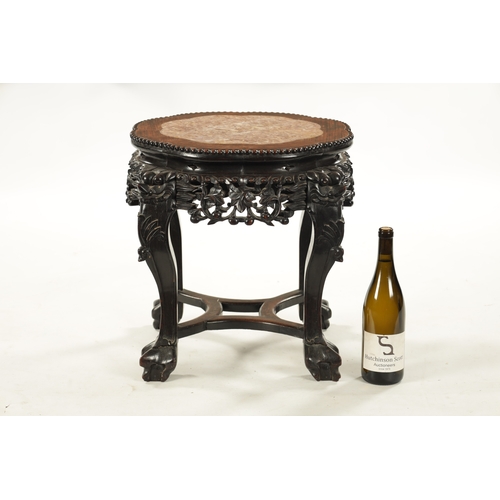 559 - A 19TH CENTURY CHINESE HARDWOOD JARDINIERE STAND with inset marle top above a carved pierced base (4... 