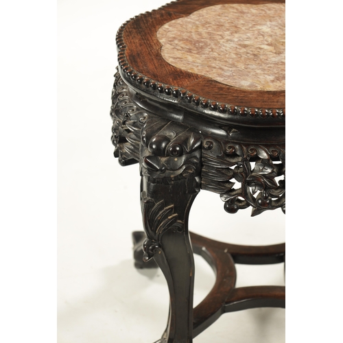 559 - A 19TH CENTURY CHINESE HARDWOOD JARDINIERE STAND with inset marle top above a carved pierced base (4... 