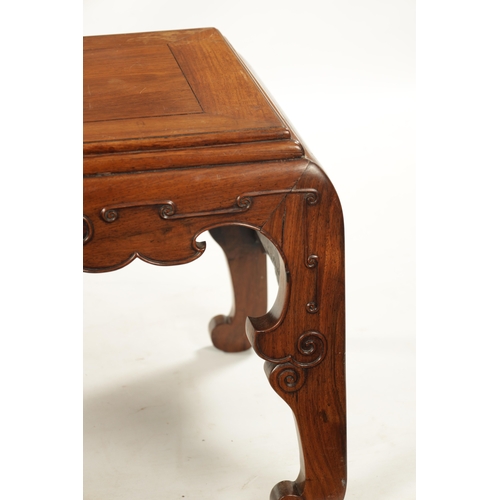 562 - A 19TH CENTURY CHINESE HUANGHUALI WOOD ALTER TABLE with panelled top above a scroll carved base join... 