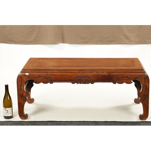 562 - A 19TH CENTURY CHINESE HUANGHUALI WOOD ALTER TABLE with panelled top above a scroll carved base join... 