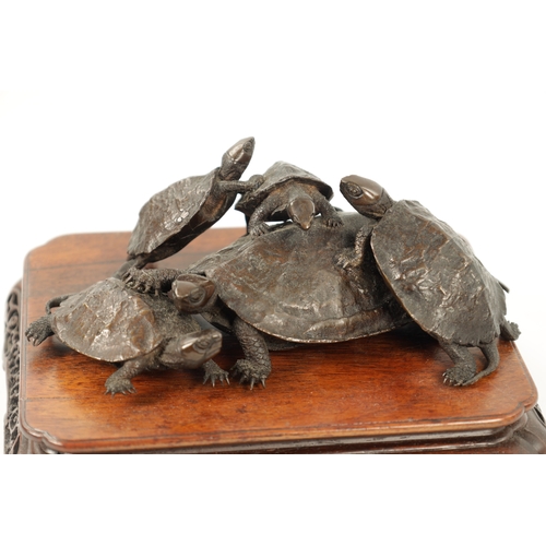 572 - A FINE JAPANESE MEIJI PERIOD BRONZE SCULPTURE OF A GROUP OF TURTLES mounted on a pierced carved hard... 