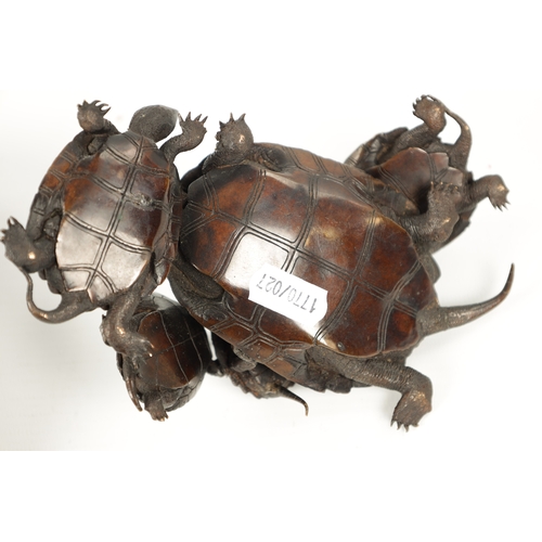 572 - A FINE JAPANESE MEIJI PERIOD BRONZE SCULPTURE OF A GROUP OF TURTLES mounted on a pierced carved hard... 