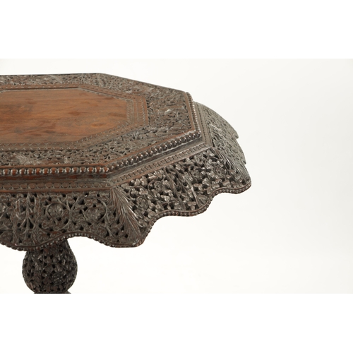 582 - A 19TH CENTURY CARVED HARDWOOD ANGLO INDIAN CENTRE TABLE with pierced leaf carved decoration above a... 