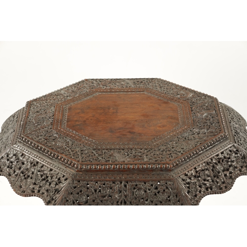 582 - A 19TH CENTURY CARVED HARDWOOD ANGLO INDIAN CENTRE TABLE with pierced leaf carved decoration above a... 