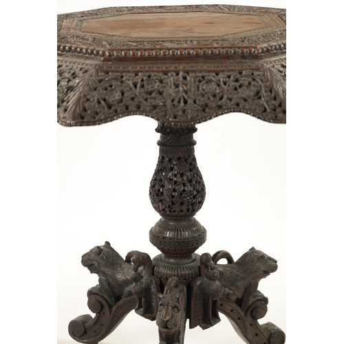 582 - A 19TH CENTURY CARVED HARDWOOD ANGLO INDIAN CENTRE TABLE with pierced leaf carved decoration above a... 