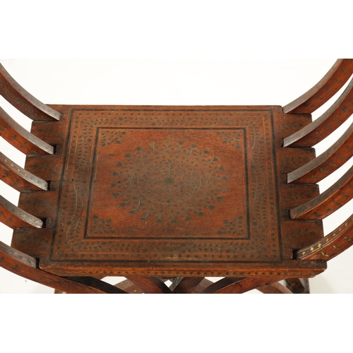 584 - A 19TH CENTURY INDIAN HARDWOOD AND BRASS INLAID FOLDING SAVONAROLA ARMCHAIR with peacock-shaped back... 