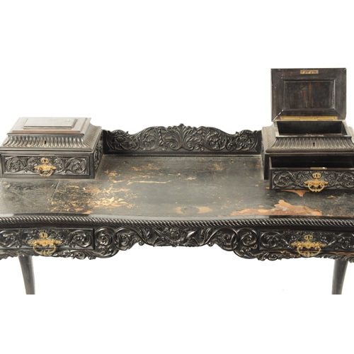 593 - A 19TH CENTURY CARVED COROMANDEL INDO-PORTUGUESE WRITING DESK of serpentine shape with leaf-carved d... 