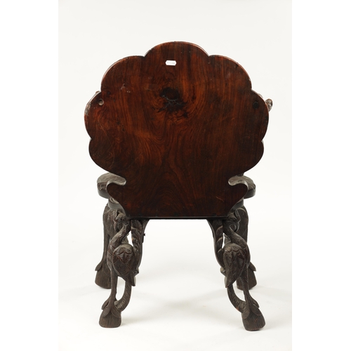 594 - A 19TH CENTURY ANGLO-INDIAN CARVED HARDWOOD ARMCHAIR decorated with flamingo and serpent panels on a... 