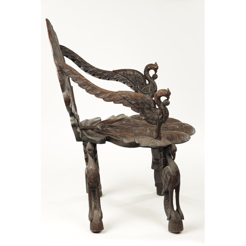 594 - A 19TH CENTURY ANGLO-INDIAN CARVED HARDWOOD ARMCHAIR decorated with flamingo and serpent panels on a... 