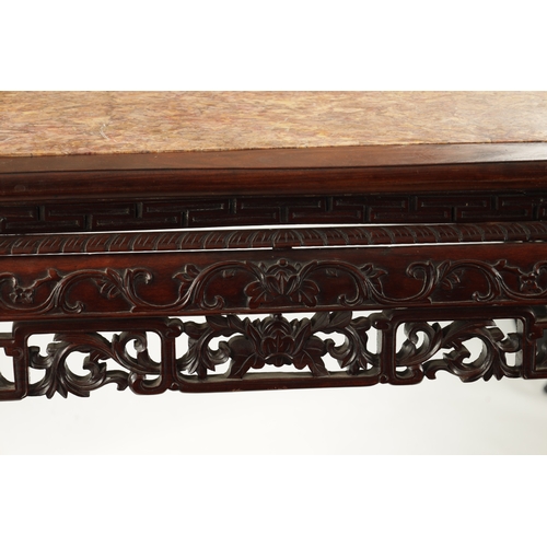 598 - A 19TH CENTURY CHINESE HARDWOOD ALTER TABLE with inset marble top above peirced carved leafwork base... 