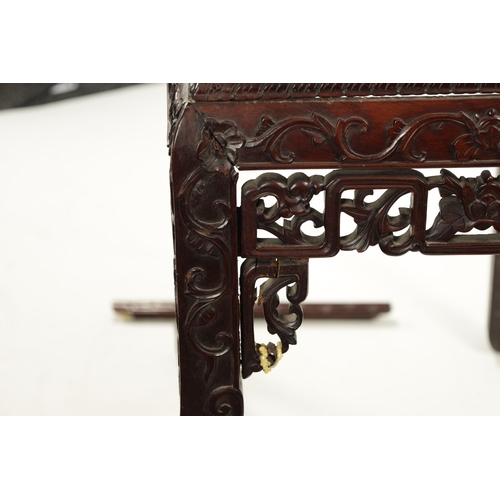 598 - A 19TH CENTURY CHINESE HARDWOOD ALTER TABLE with inset marble top above peirced carved leafwork base... 