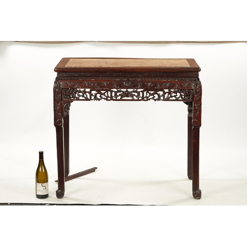 598 - A 19TH CENTURY CHINESE HARDWOOD ALTER TABLE with inset marble top above peirced carved leafwork base... 