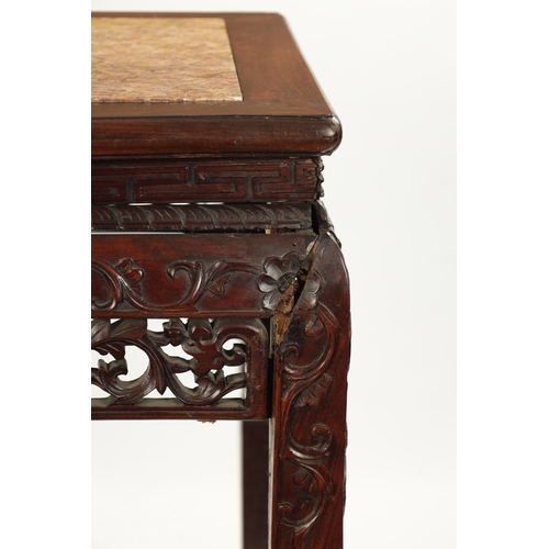 598 - A 19TH CENTURY CHINESE HARDWOOD ALTER TABLE with inset marble top above peirced carved leafwork base... 