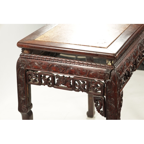 598 - A 19TH CENTURY CHINESE HARDWOOD ALTER TABLE with inset marble top above peirced carved leafwork base... 