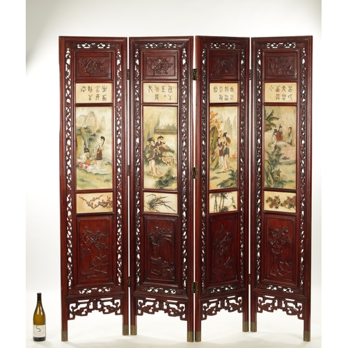 599 - AN EARLY 20TH CENTURY CHINESE FOUR-SECTION FOLDING SCREEN having pierced carved hardwood frames encl... 