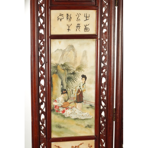 599 - AN EARLY 20TH CENTURY CHINESE FOUR-SECTION FOLDING SCREEN having pierced carved hardwood frames encl... 