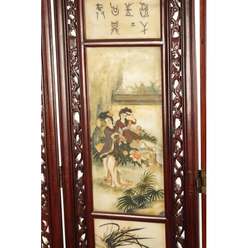 599 - AN EARLY 20TH CENTURY CHINESE FOUR-SECTION FOLDING SCREEN having pierced carved hardwood frames encl... 