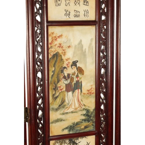 599 - AN EARLY 20TH CENTURY CHINESE FOUR-SECTION FOLDING SCREEN having pierced carved hardwood frames encl... 