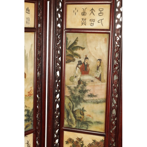 599 - AN EARLY 20TH CENTURY CHINESE FOUR-SECTION FOLDING SCREEN having pierced carved hardwood frames encl... 