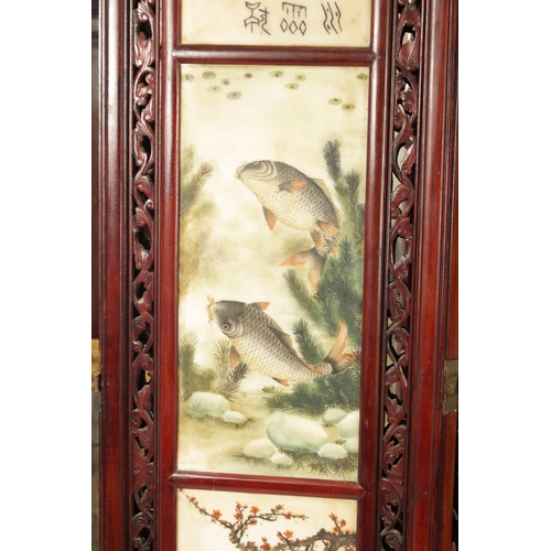 599 - AN EARLY 20TH CENTURY CHINESE FOUR-SECTION FOLDING SCREEN having pierced carved hardwood frames encl... 