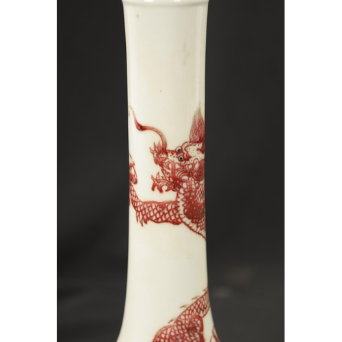 600 - A 19TH CENTURY CHINESE IRON RED BOTTLE VASE decorated with a entwined dragon - bearing six character... 