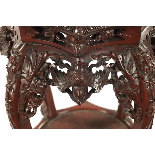 605 - A 19TH CENTURY CHINESE CARVED HARDWOOD JARDINIERE STAND the shaped top with carved border enclosing ... 