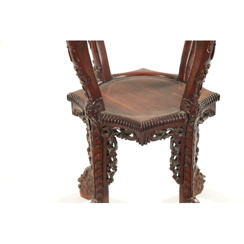 605 - A 19TH CENTURY CHINESE CARVED HARDWOOD JARDINIERE STAND the shaped top with carved border enclosing ... 