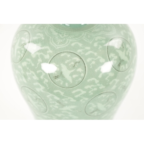 607 - A SIGNED KOREAN CELADON CRACKLE GLAZED VASE decorated with flying cranes amongst clouds, signed to u... 