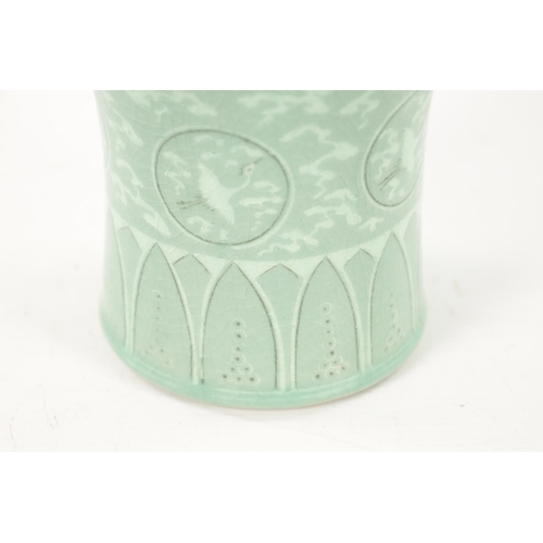 607 - A SIGNED KOREAN CELADON CRACKLE GLAZED VASE decorated with flying cranes amongst clouds, signed to u... 