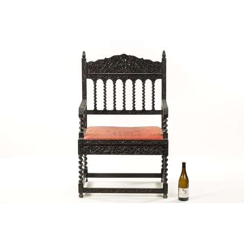 608 - A GOOD 18TH CENTURY CARVED INDIAN COROMANDEL COAST EBONY ARMCHAIR with leaf carved frame, barley twi... 