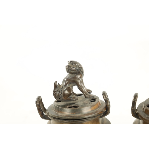 609 - A PAIR OF CHINESE LIDDED INCENSE BURNERS two-handled bodies with foo dog finials and elephant mask l... 