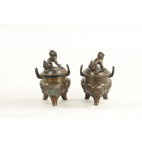 609 - A PAIR OF CHINESE LIDDED INCENSE BURNERS two-handled bodies with foo dog finials and elephant mask l... 