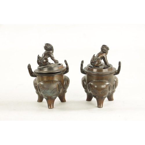 609 - A PAIR OF CHINESE LIDDED INCENSE BURNERS two-handled bodies with foo dog finials and elephant mask l... 