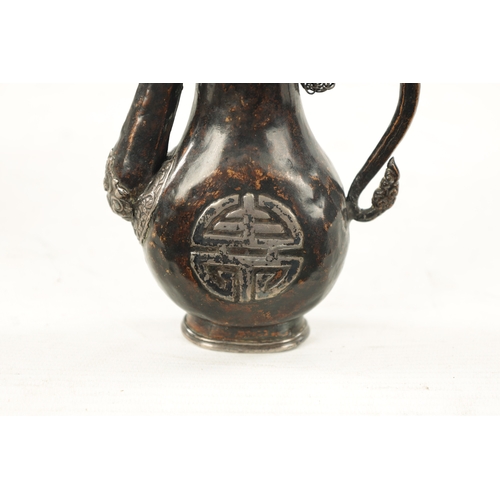 617 - A 19TH CENTURY MINIATURE EASTERN MIXED METAL EWER with a calligraphic symbol on each side and dragon... 