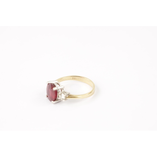 620 - AN 18CT GOLD RUBY AND DIAMOND RING having an oval cut ruby flanked by two brilliant cut diamonds all... 