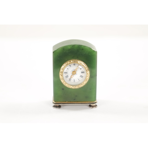 627 - A 19TH CENTURY FABERGE STYLE CONTINENTAL NEPHRITE AND SILVER BOUDOIR CLOCK with chamfered arched bod... 