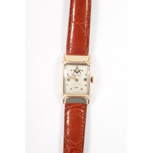 630 - A 1940’S ROLLED GOLD BULOVA MASONIC WRISTWATCH on brown alligator leather strap, the slightly curved... 