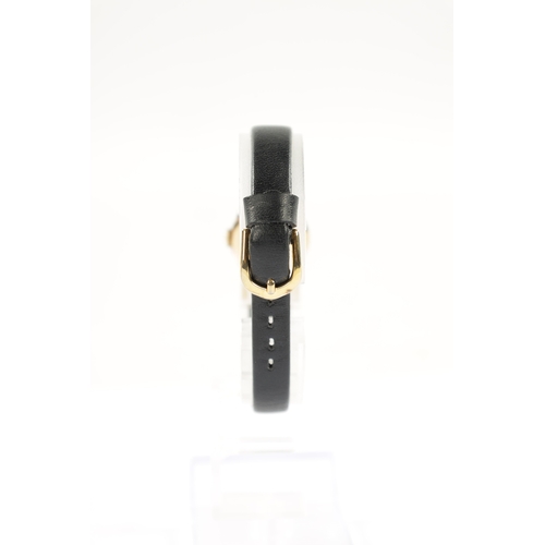 640 - A LADIES OMEGA WRISTWATCH on black leather strap, the rolled gold case enclosing an unusual black ho... 