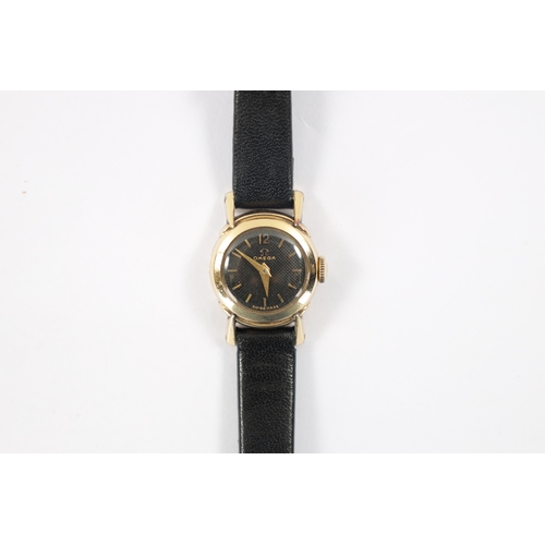 640 - A LADIES OMEGA WRISTWATCH on black leather strap, the rolled gold case enclosing an unusual black ho... 