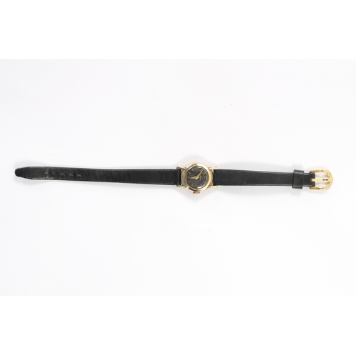 640 - A LADIES OMEGA WRISTWATCH on black leather strap, the rolled gold case enclosing an unusual black ho... 