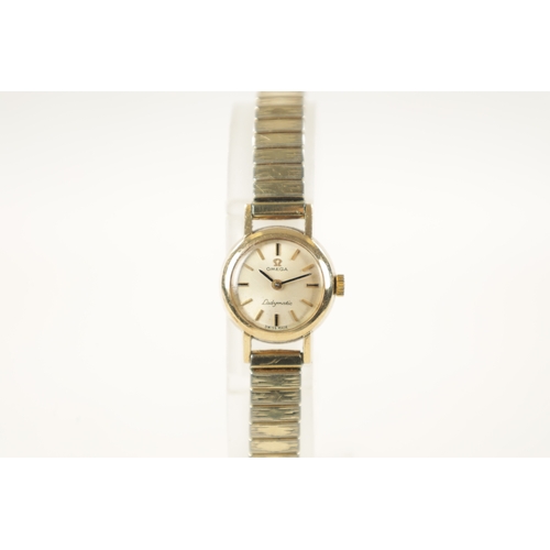 644 - AN OMEGA LADYMATIC 9CT GOLD AUTOMATIC LADY'S WRISTWATCH on an elasticated steel bracelet.