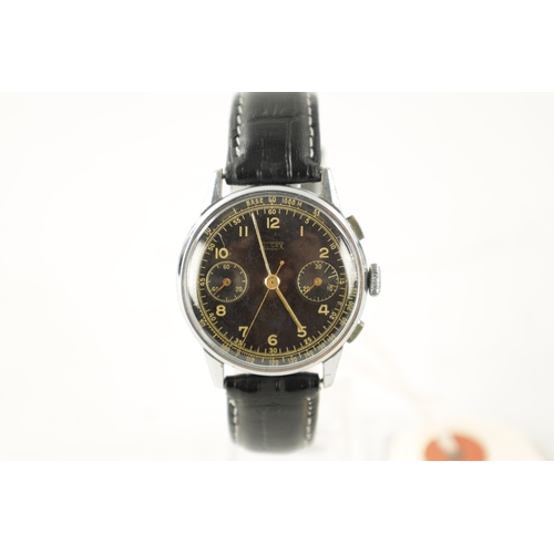 650 - A GENTLEMAN’S 1960’S STEEL-CASED HUGEX CHRONOGRAPH WRISTWATCH on black leather strap, having a black... 