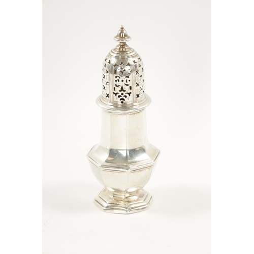 667 - A GEORGE II SILVER SUGAR CASTER of crested faceted baluster form, domed cover and turned finial. Lon... 