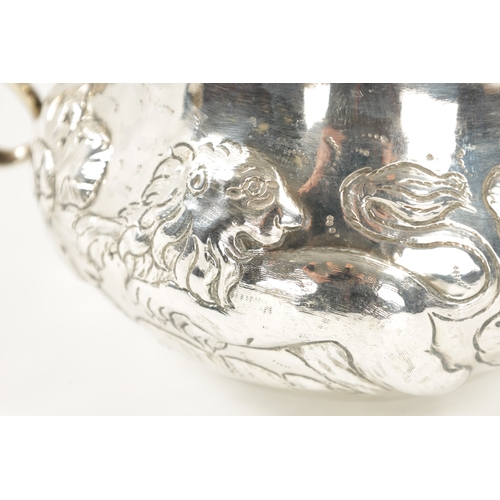 669 - A FINE CHARLES II OVERSIZED SILVER PORRINGER of bellied form embossed with a continuous band of leaf... 