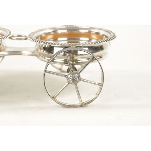 680 - A 19TH CENTURY NOVELTY SILVER PLATED TABLE TOP DOUBLE COASTER TROLLEY FORMED AS A CARRIAGE with ivor... 