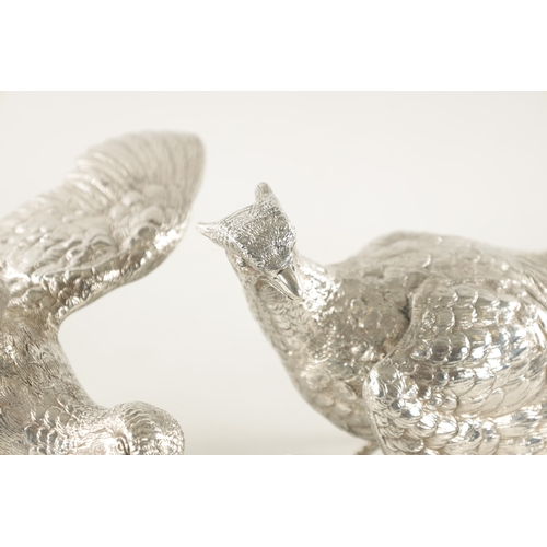 682 - A PAIR OF 20TH CENTURY MAPPIN & WEBB SILVER PHEASANTS realistically modelled as a hen and cock pheas... 