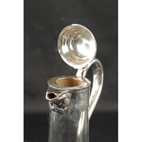 688 - A VICTORIAN SILVER MOUNTED GLASS CLARET JUG with star-cut bulbous base and engraved mask-head silver... 