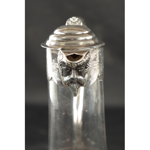 688 - A VICTORIAN SILVER MOUNTED GLASS CLARET JUG with star-cut bulbous base and engraved mask-head silver... 