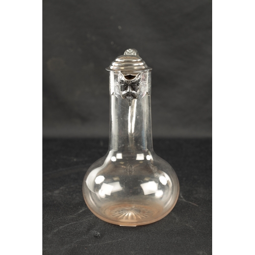 688 - A VICTORIAN SILVER MOUNTED GLASS CLARET JUG with star-cut bulbous base and engraved mask-head silver... 